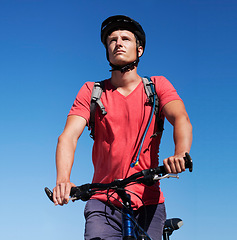 Image showing Sky, bike and man focus on cycling journey, sports workout or travel adventure for fitness, exercise or outdoor cardio. Thinking, athlete training and male person riding bicycle for transportation