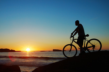 Image showing Man, beach and silhouette with mountain bike, sunset and mockup space by waves for summer cycling adventure. Cyclist, freedom and fitness with bicycle, training or journey by ocean in dusk sunshine