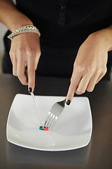 Image showing Pills, plate and hands of woman with cutlery for anorexia, eating disorder and weight loss issue. Drugs, health and female person with knife and fork cutting diet pill or medication for food problem