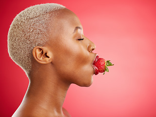 Image showing Woman, strawberry and studio for beauty, profile and skincare for wellness, health and diet by red background. African model girl, healthy fruit and mouth with eyes closed, nutrition and cosmetics