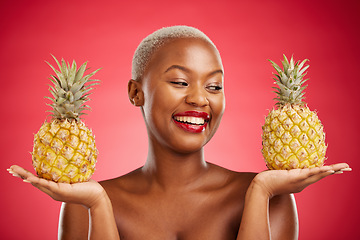 Image showing Pineapple, beauty and face of a woman in studio for healthy food, diet or fruit. Black female model with makeup on red background for wellness glow, natural cosmetics and tropical or citrus skin care