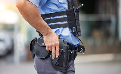 Image showing Gun, uniform and police in the city for crime, security and outdoor justice in the street. Law, safety and a closeup of a man with a weapon in town for legal services, criminal or protection