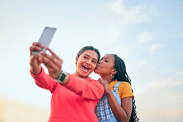 Image showing Selfie, kiss and friends posing together outdoor during summer to update a profile picture or status. Photograph, love and bonding with excited young women posting to social media while in nature