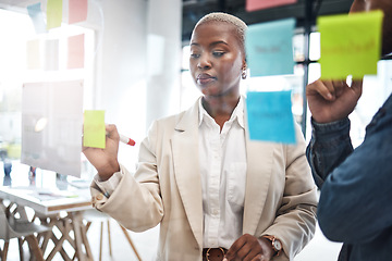 Image showing Black woman, writing and schedule planning in meeting for brainstorming, teamwork or tasks at office. African female person or employee working on team strategy, ideas or business agenda at workplace