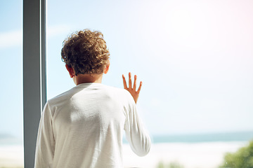 Image showing Sad, depression and hope of a child at window while bored lonely and thinking. Depressed, psychology and autism boy child with anxiety problem in isolation with hand by mockup space in house