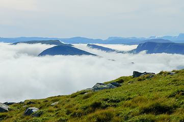 Image showing Mountain peaks poked out of the fog at the coast