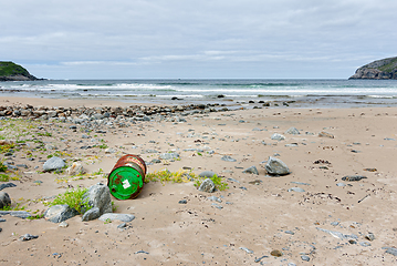 Image showing Oil barrel lying on the beach