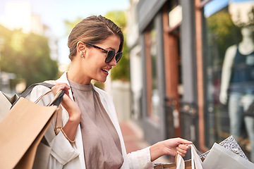 Image showing Fashion, shopping bag or happy rich woman in city walking on urban street for boutique retail sale or clothes. Sunglasses, financial freedom or girl customer on road searching for luxury products