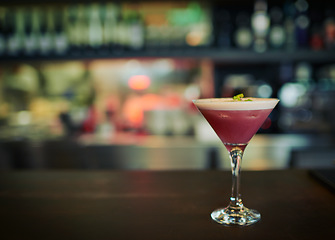 Image showing Fruit cocktail, glass and alcohol drink on counter at pub, night club and bar for restaurant service. Nightclub mockup, party and closeup of pink beverage on wooden table for person with copy space