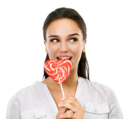 Image showing Happy, candy and woman with a lollipop for a sweets craving, dessert or sugar. Happiness, snack and young female model eating a heart shape sweet while isolated on a transparent png background