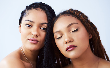 Image showing Beautifully brown and glowing. Studio shot of two beautiful young women posing against a grey background.