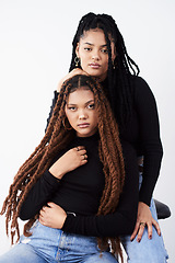 Image showing Long natural hair is what they love. Studio shot of two beautiful young women posing against a grey background.