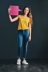 Image showing Speak up when it will help others. Studio shot of a beautiful young woman holding a speech bubble.