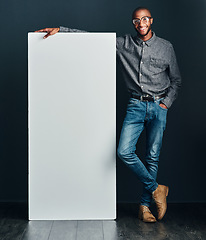 Image showing I have something I would like to introduce to you. Shot of a handsome young man standing next to a blank placard.