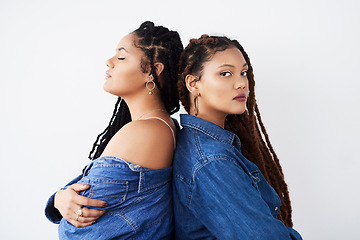 Image showing They love to match their catching style. Studio shot of two beautiful young women posing against a grey background.