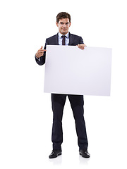 Image showing Getting your attention with a large sign. A handsome young businessman holding a large placard.