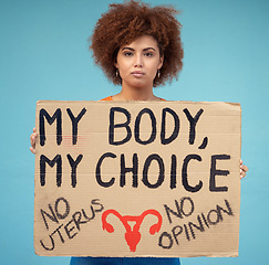 Image showing Black woman, portrait and poster to protest abortion, body choice and freedom of human rights in studio. Feminist, rally and sign for safe decision, equality and support of justice on blue background