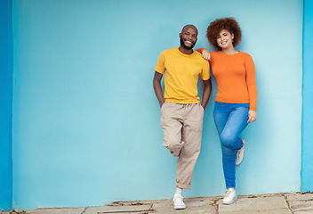 Image showing Interracial, portrait and couple on a city wall for travel, holiday and happy in Germany. Smile, relax and black man and woman standing on a mockup background downtown during a vacation together