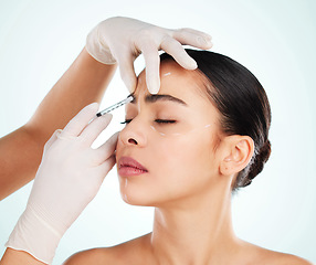 Image showing Woman, skincare and face injection for plastic surgery in studio isolated on white background. Facial, syringe and cosmetics of female model with collagen filler for dermatology, beauty or aesthetic.