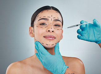 Image showing Portrait, plastic surgery and botox with a woman in studio on a gray background for a facelift injection. Doctor, medical and improvement with hands in gloves holding a syringe for facial collagen