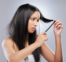 Image showing Hair crisis, damage and woman in studio with worry for split ends, haircare crisis and weak tips. Beauty, hairdresser and face of worried female person with frizz strand problem on gray background