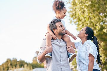 Image showing Family, love and parents with their daughter in nature, sitting on shoulders in a park during summer. Mother, father and girl child bonding together outdoor in the countryside or a garden for freedom