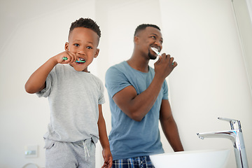 Image showing African father, bathroom and son with toothbrush, care or love for cleaning, hygiene or dental wellness. Black man, boy and brushing teeth in family house with health, smile or clean mouth in morning