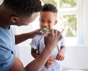 Image showing African father, teaching son and toothbrush with care, love or support for cleaning, hygiene or dental wellness. Black man, boy and brushing teeth in home bathroom with health, smile and helping hand