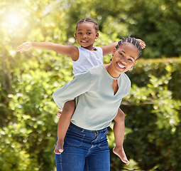 Image showing Black family, portrait and piggy back outdoor with happiness and smile in a park. Mom, young girl and happy kid in nature with mother and child together on a lawn on summer holiday having fun