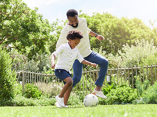 Image showing Soccer, happy dad and kid on a garden with exercise, sport learning and goal kick together. Lawn, fun game and black family with football on grass with youth, sports development and bonding on field