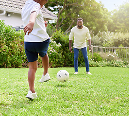 Image showing His coordination gets better with practice. Shot of a little boy kicking a soccer ball to his father while playing together outdoors.