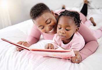 Image showing Book, reading and mother with child in bed for learning, bond and fantasy at home. Storytelling, family and parent with girl in a bedroom with notebook for literature, relax and fun in their house