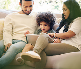 Image showing Mother, father and child learning on a tablet in a family home for development and internet. Man, woman and son or a kid together on a home sofa with technology for education, games and online app