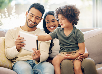 Image showing Father, mother and a child learning on a tablet in a family home with happiness, development and internet. Man, woman and son or kid together on home sofa with tech for education, games or online app