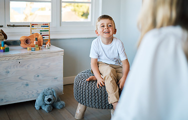 Image showing Therapist, psychology and boy on a chair, talking and child development with a smile, foster home and adoption. Male kid, young person or counsellor in an office, speaking and consultation for growth