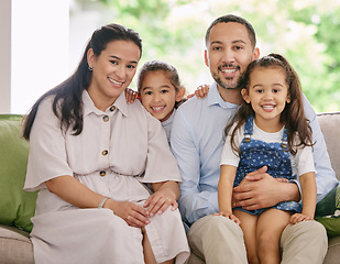 Image showing Happy, smile and family portrait on a sofa with love, embrace and bonding in their home together. Face, children and parents on a couch relax, sweet or embracing in living room, cheerful and chilling