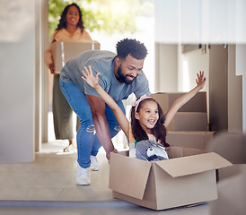 Image showing Happy family, real estate and moving in new home with box for property, mortgage loan or celebration. Mother, father and little girl enjoying playing with boxes for fun relocation together in house