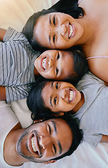 Image showing Portrait, smile and above asian family in bed, relax and having fun while bonding in their home. Top view, love and face of children with parents in bedroom, happy and resting together on the weekend