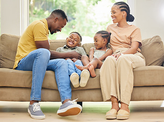 Image showing Tickling, laughing and black family with children on home sofa for happiness, love and care. African kids, man and a woman or parents together on couch for fun, quality time and bonding while playing