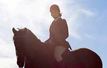 Image showing Equestrian, lens flare and portrait of woman on horse for competition, training and show. Performance, riding and fitness with female jockey on stallion for animal, athlete and contest event