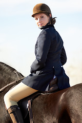 Image showing Equestrian, sports and portrait of woman on horse for competition, training and show. Performance, riding and fitness with female jockey on stallion for animal, athlete and contest event