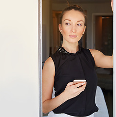 Image showing Waiting for an important text. Shot of a young woman using her cellphone in her hotel room.