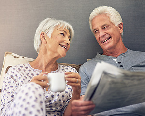 Image showing Coffee, newspaper and a mature couple in bed, enjoying retirement in their home in the morning. Tea, reading or love with a happy senior man and woman in the bedroom together to relax while bonding