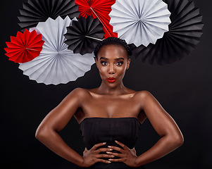 Image showing Face, beauty and black woman with origami fans in studio isolated on a dark background. Portrait, makeup cosmetics and skincare of female model with traditional Japanese paper hat for fashion art.
