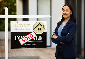 Image showing Sold board, realtor woman and portrait with arms crossed for home investment, property sale and agency success. Happy face of real estate agent, landlord or biracial person, new house poster or sign