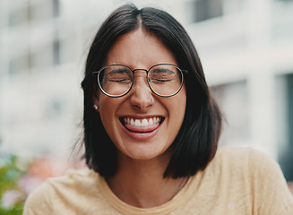 Image showing A little bit of fun never hurt anyone. Cropped shot of an attractive young businesswoman sitting alone outside and feeling playful while making a face.