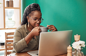 Image showing Coffee blogging is kinda her thing. Shot of a young woman having coffee and using a laptop at a cafe.