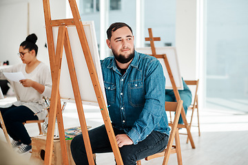 Image showing I wonder what colour I should use. Cropped shot of a handsome young artist sitting and looking contemplative during an art class in the studio.