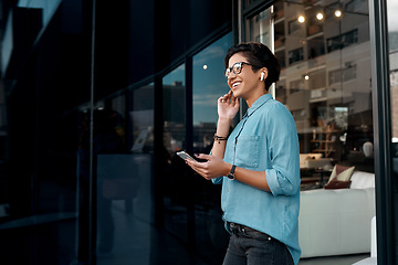 Image showing I love this song. Cropped shot of an attractive woman standing outside and putting her earpods in to listen to music through her cellphone.