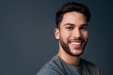 Image showing My desire for success is stronger than fear of failure. Cropped portrait of a handsome young businessman standing against a gray background alone in the studio.